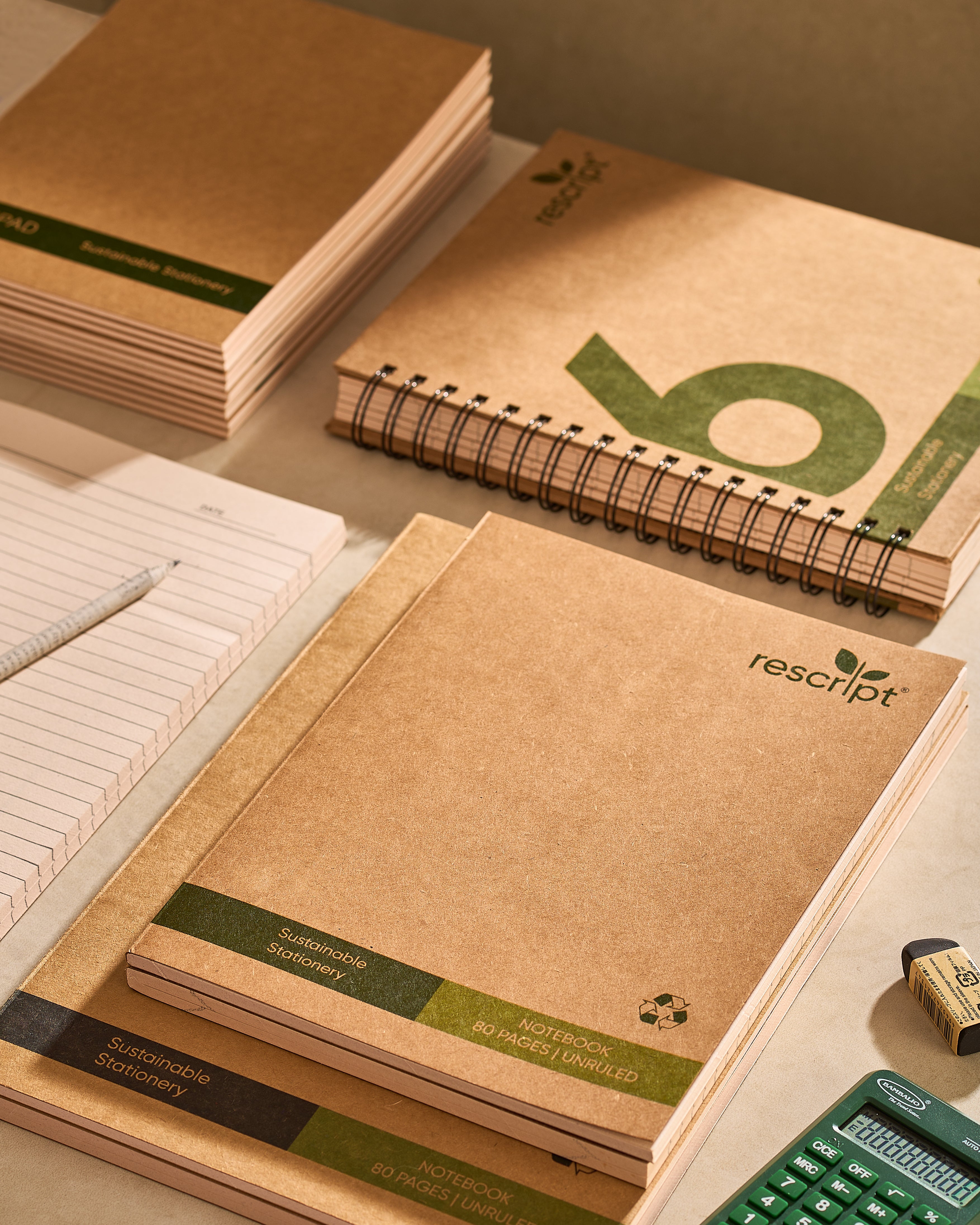 Kraft paper notebooks with visible branding on a light surface