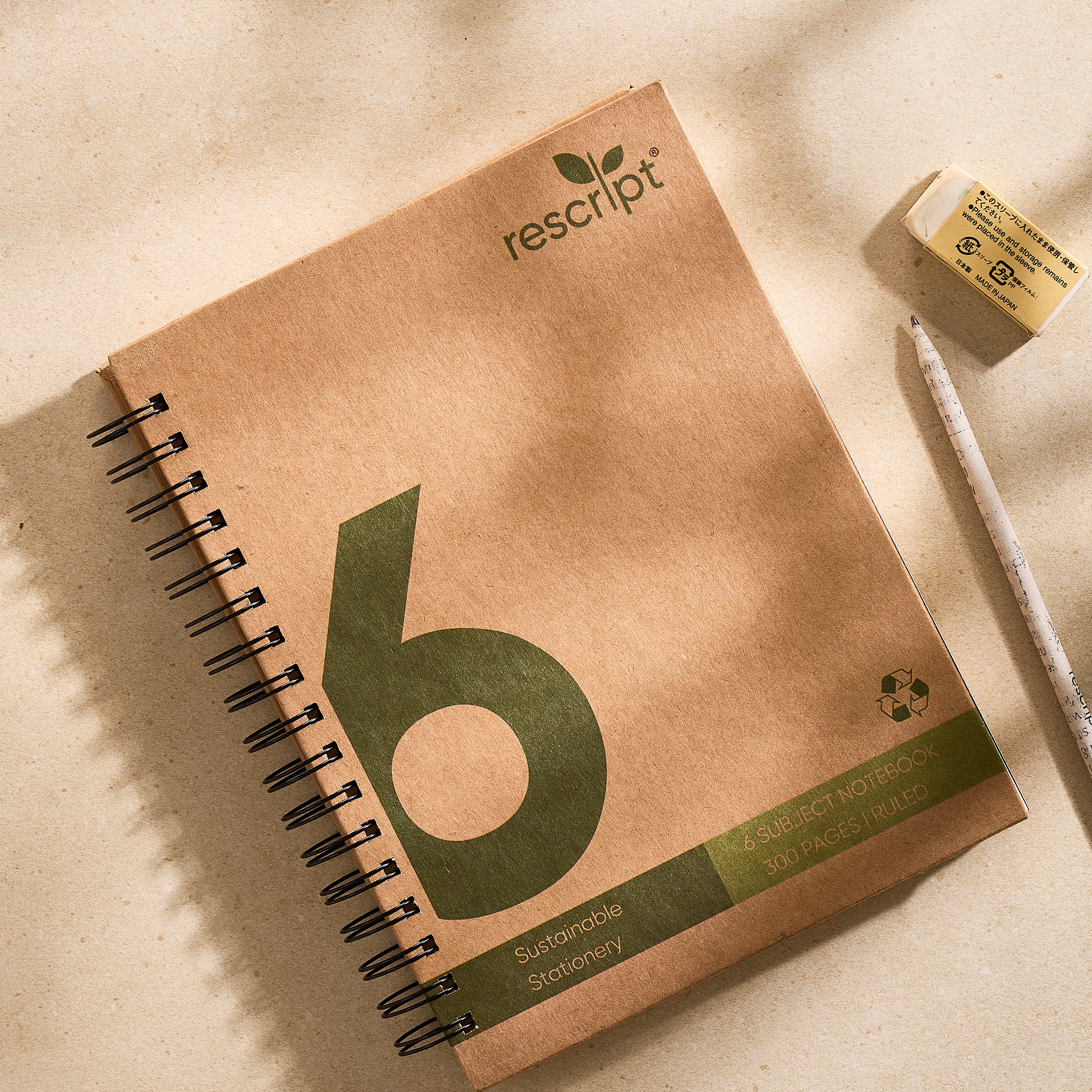 Sustainable notebook with 'rescript' branding on a beige surface