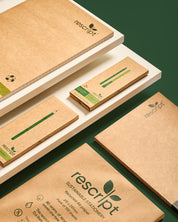 Recycled paper products with rescript branding on a green background