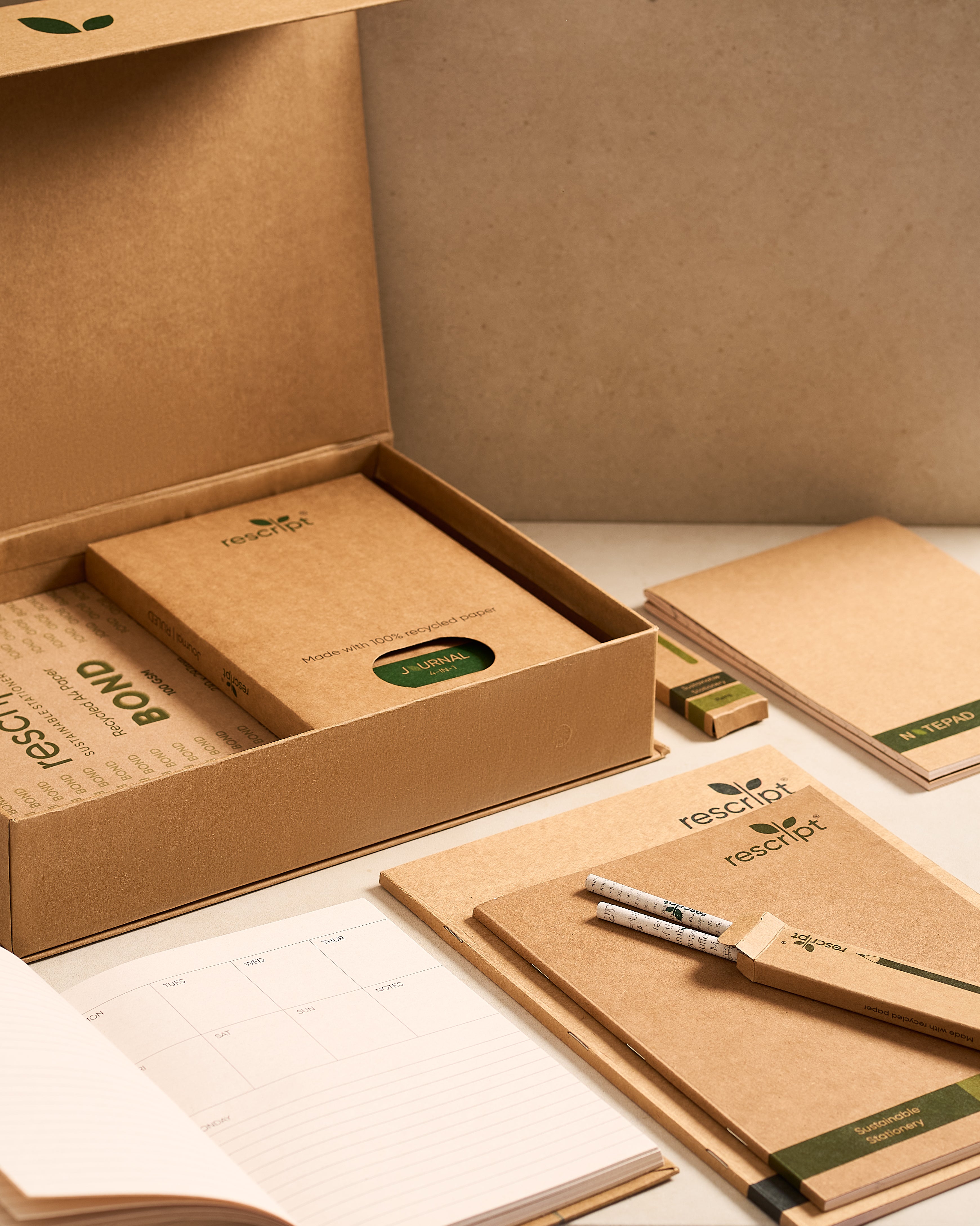Kraft paper notebooks and stationery set with 'rescued' branding on a neutral background