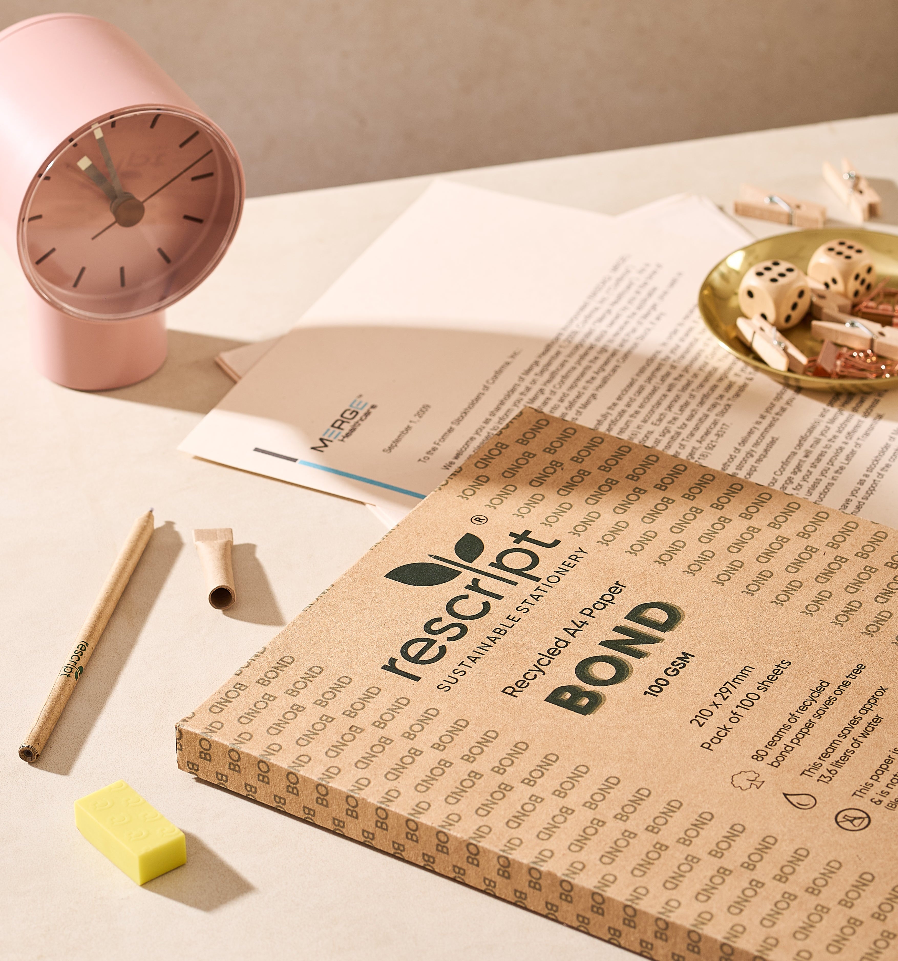 Recycled paper pad with Rescript branding on a desk with stationery items.