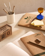 Desk setup with rescript notebooks, pens, and a calendar.
