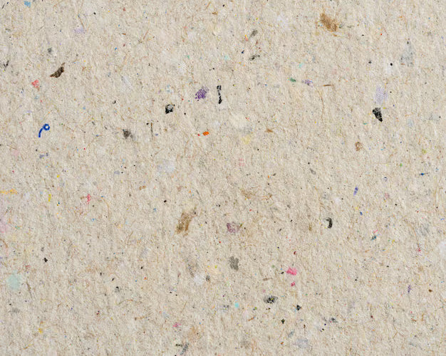 Stack of recycled paper with droplets of water to depict moisture control during monsoon printing