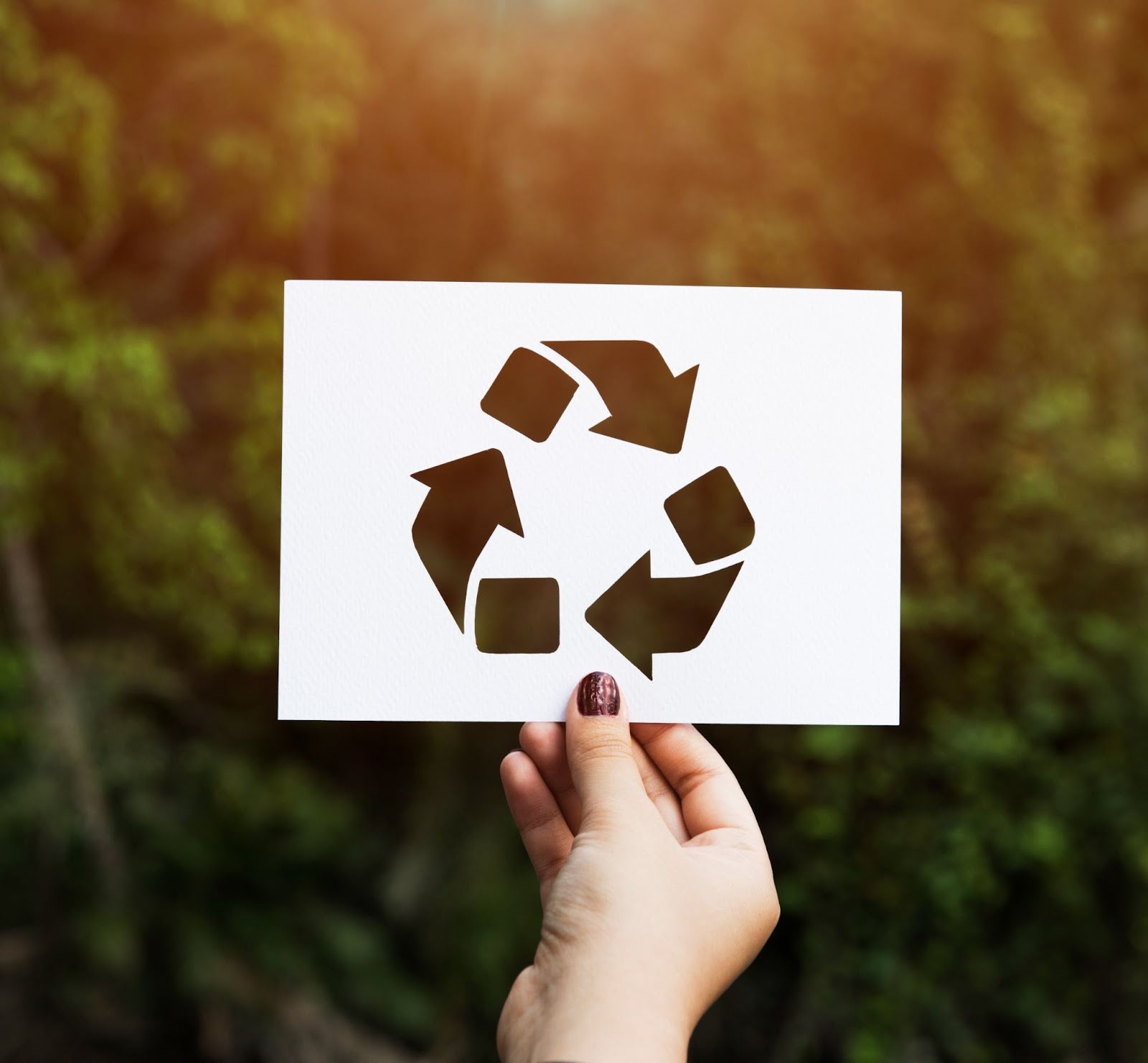 Side-by-side comparison of recycled and non-recycled copier paper stacks