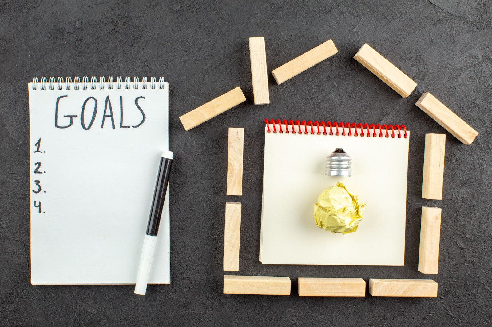 Eco-friendly recycled notebook and planner used for goal setting on a desk