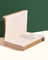 Stack of six eco-friendly notebooks with lined pages made from recycled, bleach-free paper on a beige surface